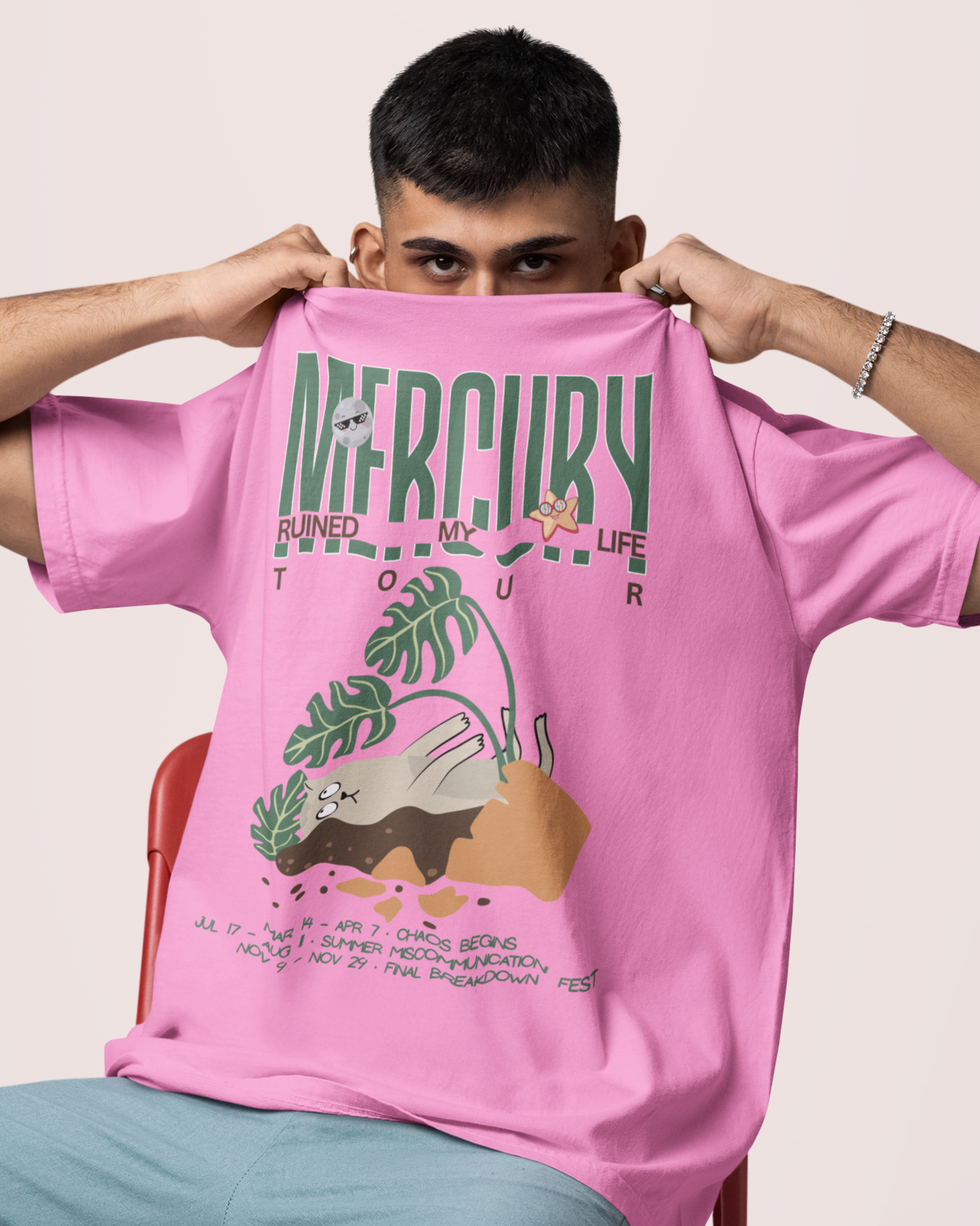 Person wearing a pink t-shirt with graphic design and text